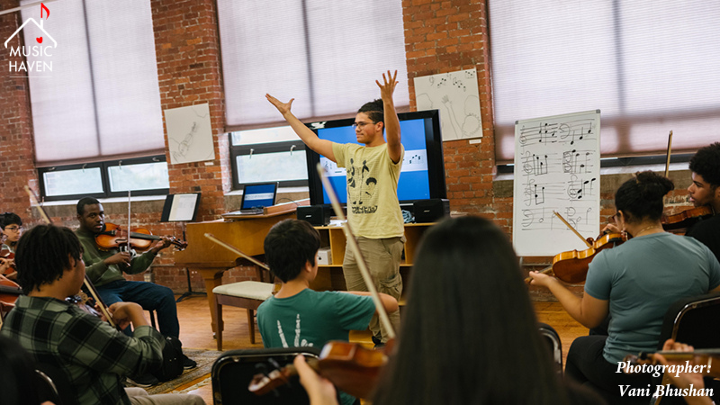 Instructor teaching music to students at Music Haven